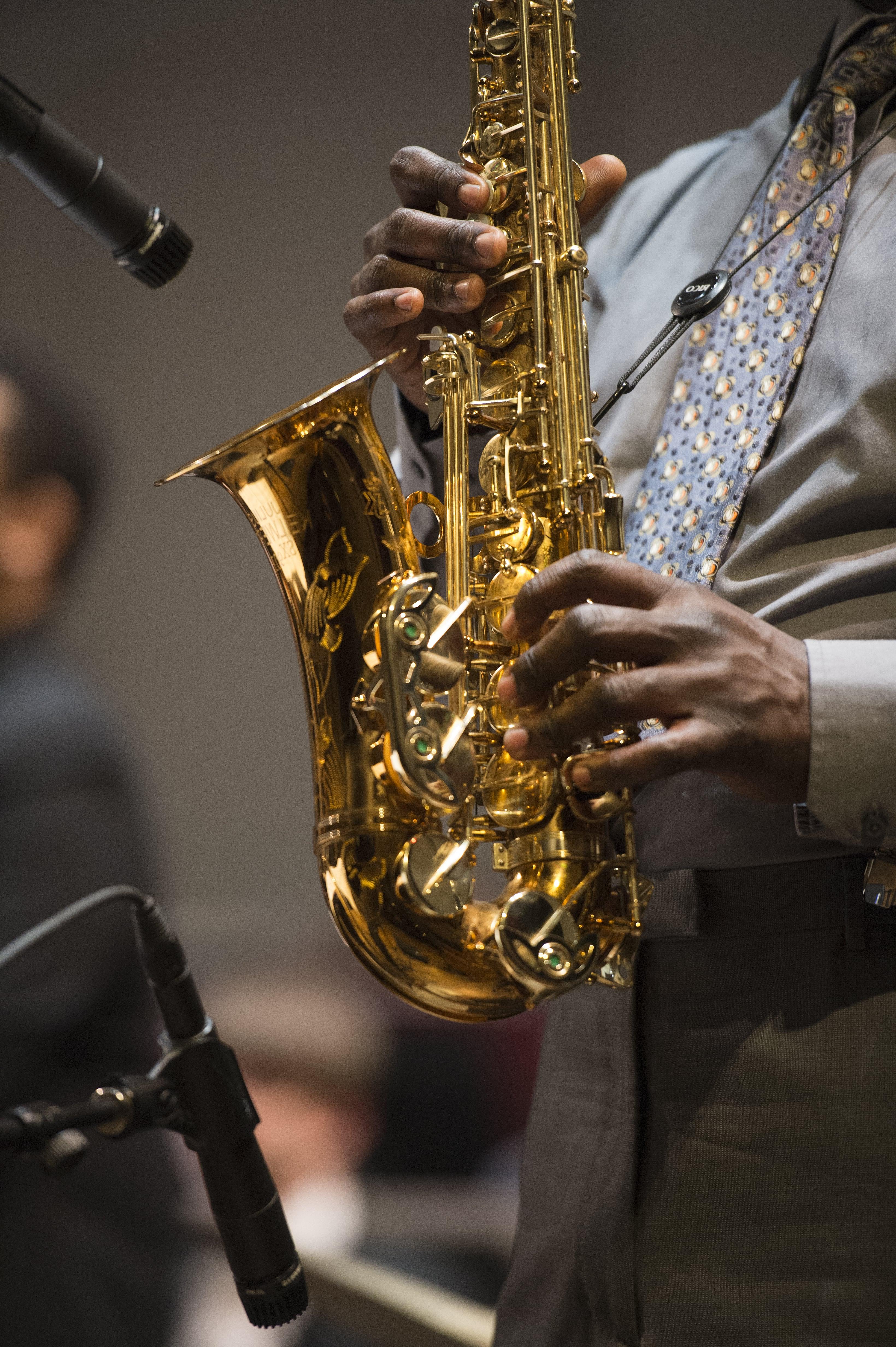 A close-up photo of a musician playing saxophone.